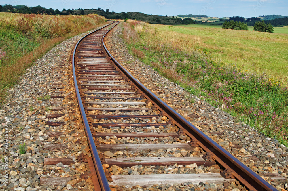 Railway sign meaning beginning of speed limit stretch at railroad  embankment with rail track disappearing in mist in background Stock Photo -  Alamy