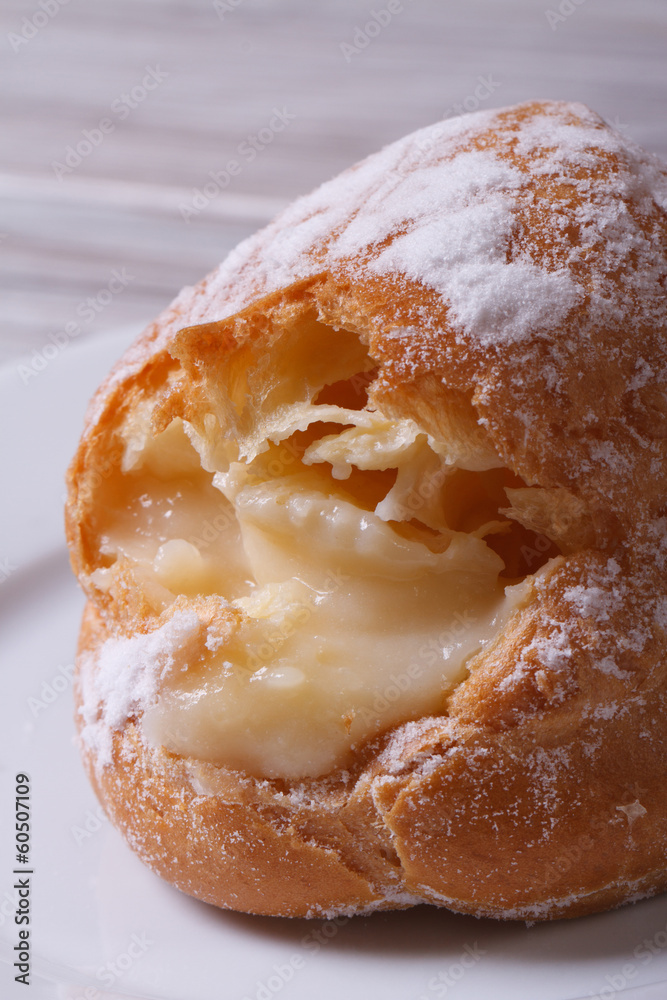 fresh custard eclair close up on the table. macro. fresh custard eclair close up on the table. macro.