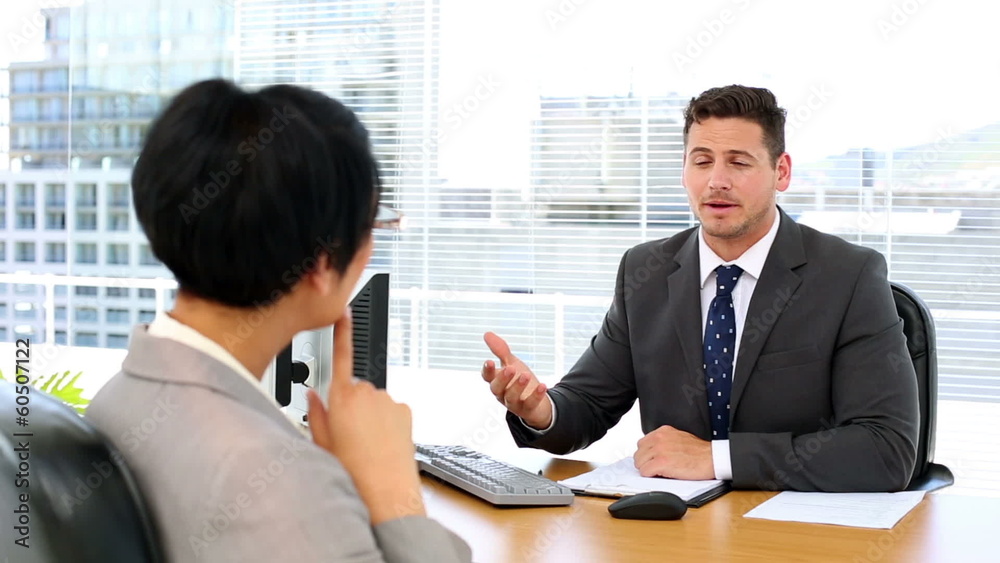 Handsome businessman talking with interviewee Handsome businessman talking with interviewee