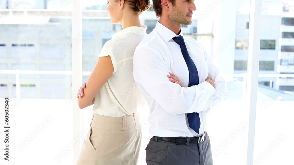 Cheerful business team standing back to back Cheerful business team standing back to back