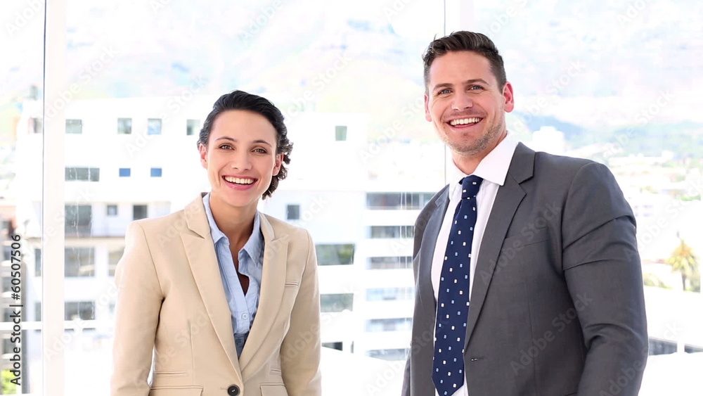 Smiling business partners putting their hands together Smiling business partners putting their hands together