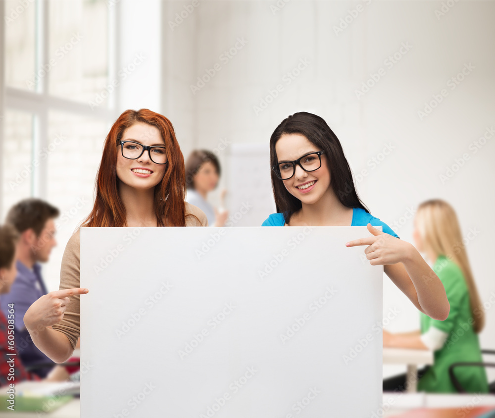 two smiling girls with eyeglasses and blank board two smiling girls with eyeglasses and blank board