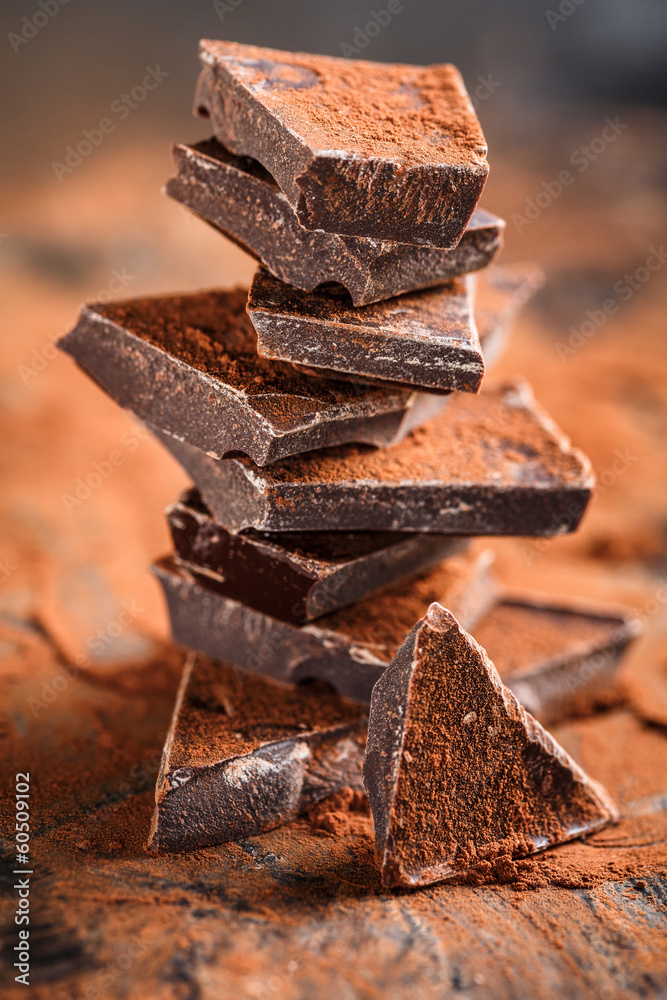 stack of dark chocolate pieces and cocoa powder Stock Photo | Adobe Stock