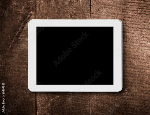 tablet touch computer on a background of wood.