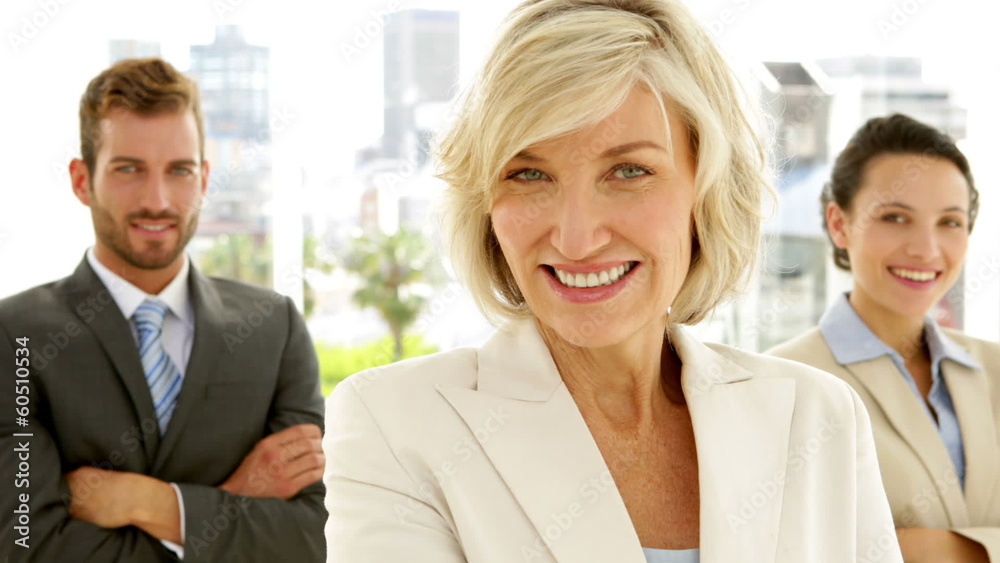 Smiling business team looking at camera