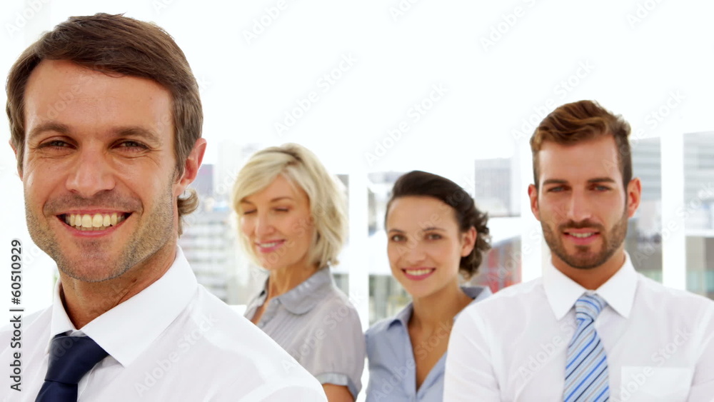 Happy business team smiling at the camera Happy business team smiling at the camera