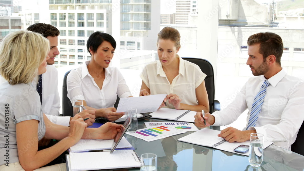 Business people going over data at meeting Business people going over data at meeting