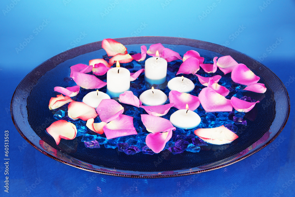 Rose petals and candles in water in vase Rose petals and candles in water in vase