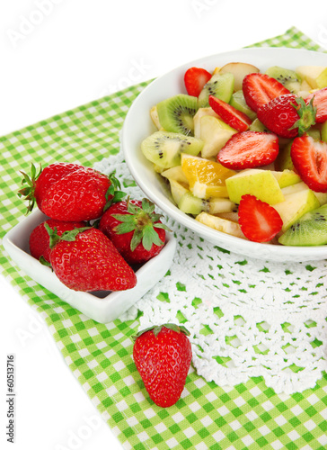 Useful fruit salad of fresh fruits and berries in bowl isolated