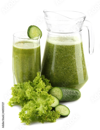 Glass and jug of green vegetable juice with cucumber isolated