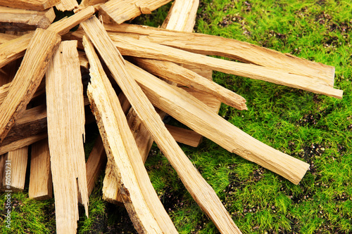 Stack of firewood on grass close up