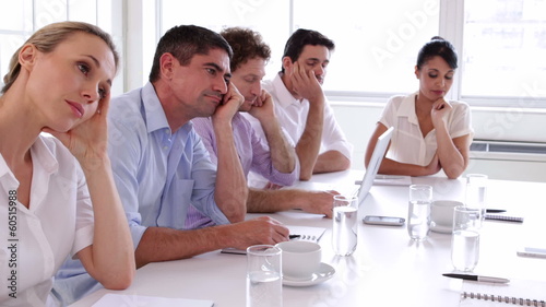 Bore business team sitting around the table