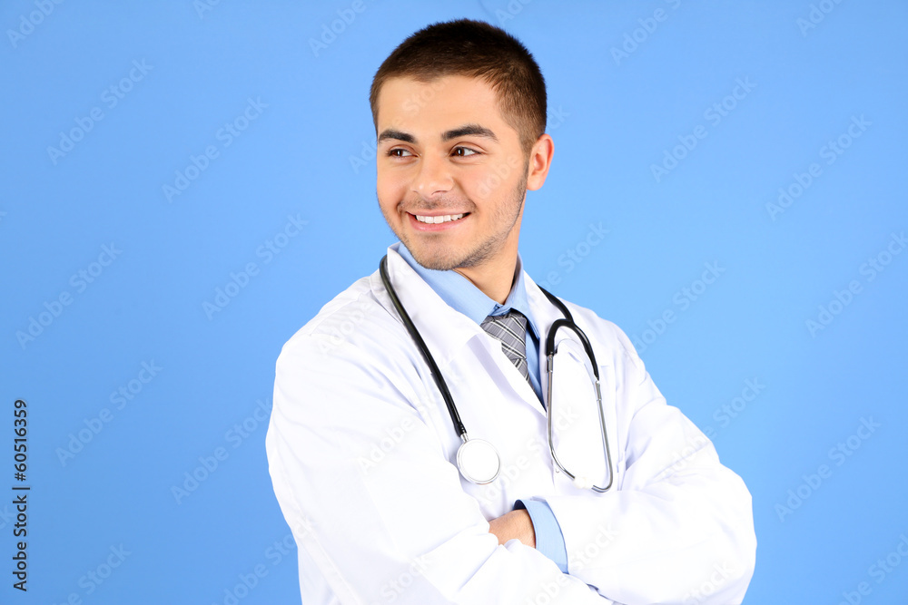 Male Doctor standing with folder, on blue background Male Doctor standing with folder, on blue background