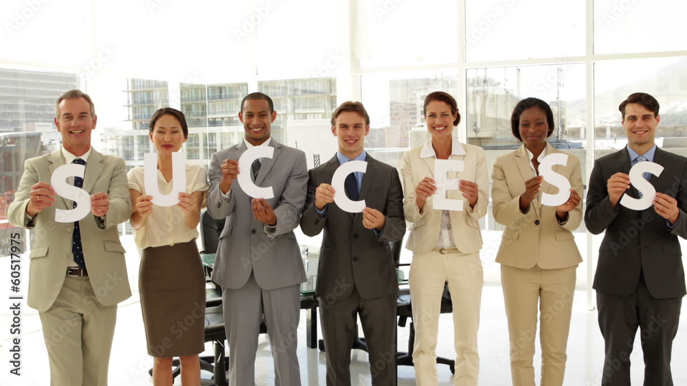 Business people holding letters spelling success Business people holding letters spelling success