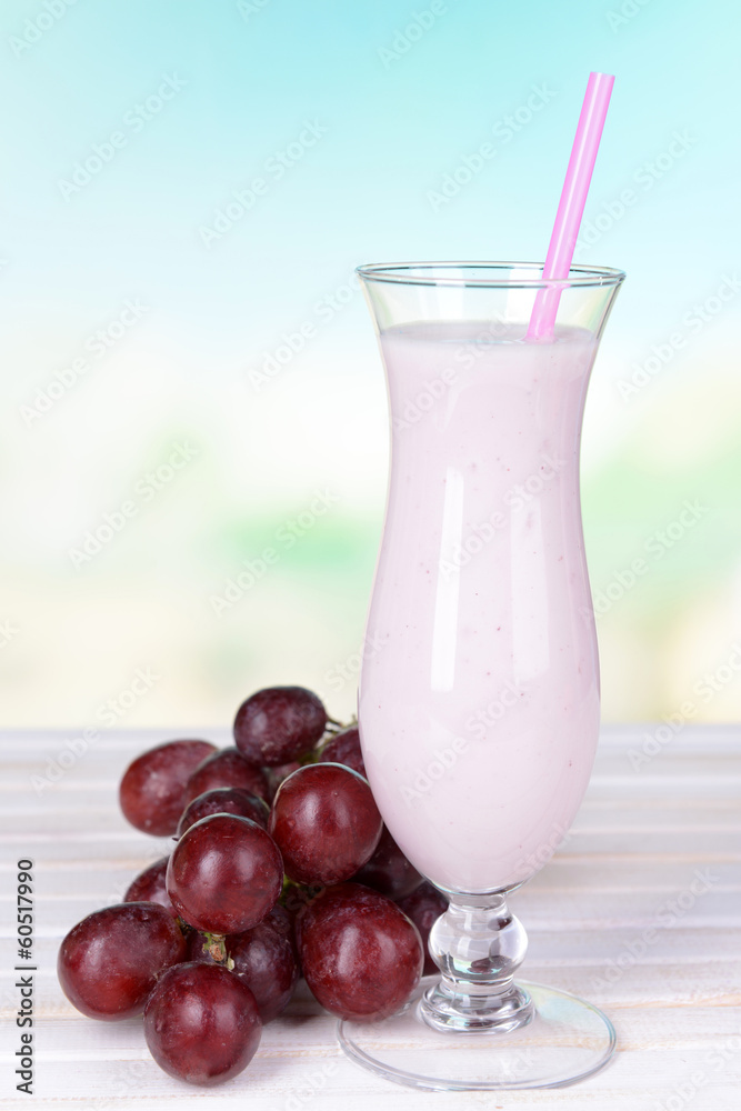 Milk shake on table on light blue background Milk shake on table on light blue background