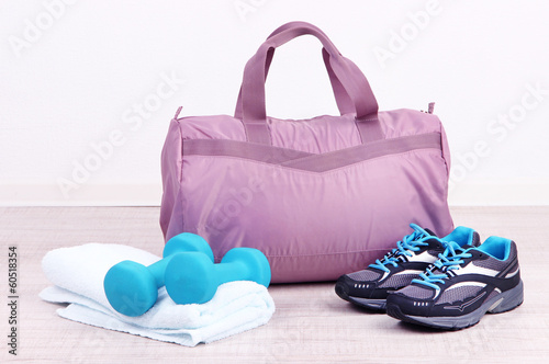 Sports bag with sports equipment in gymnasium