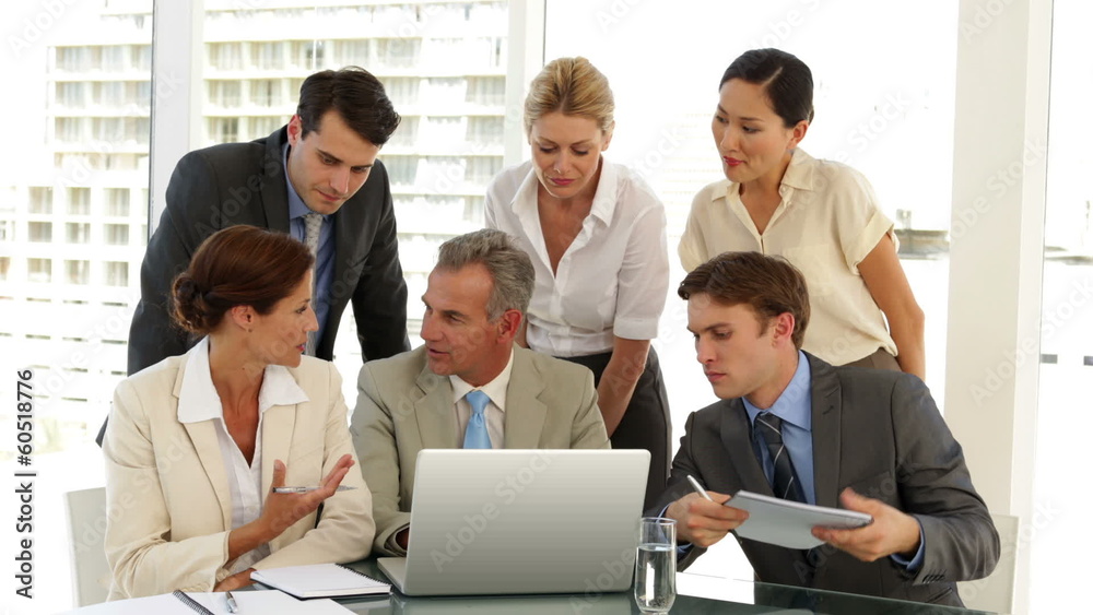 Business team discussing something on the laptop Business team discussing something on the laptop