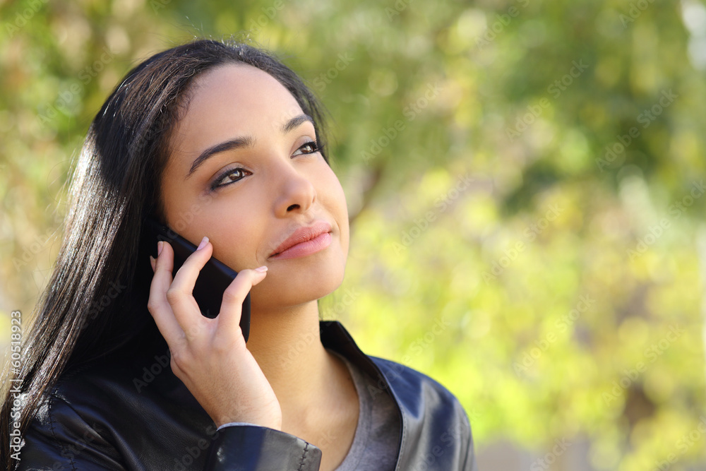 Arab business woman on the mobile phone in a park Arab business woman on the mobile phone in a park