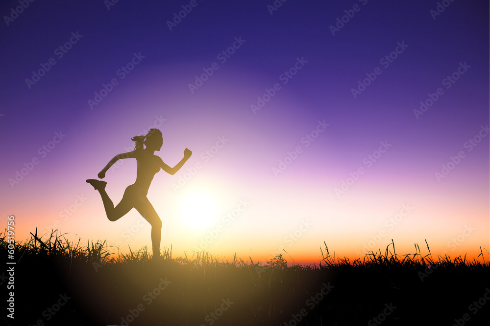 Silhouette of woman running alone at beautiful sunset