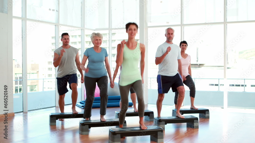 Aerobics class stepping together Aerobics class stepping together