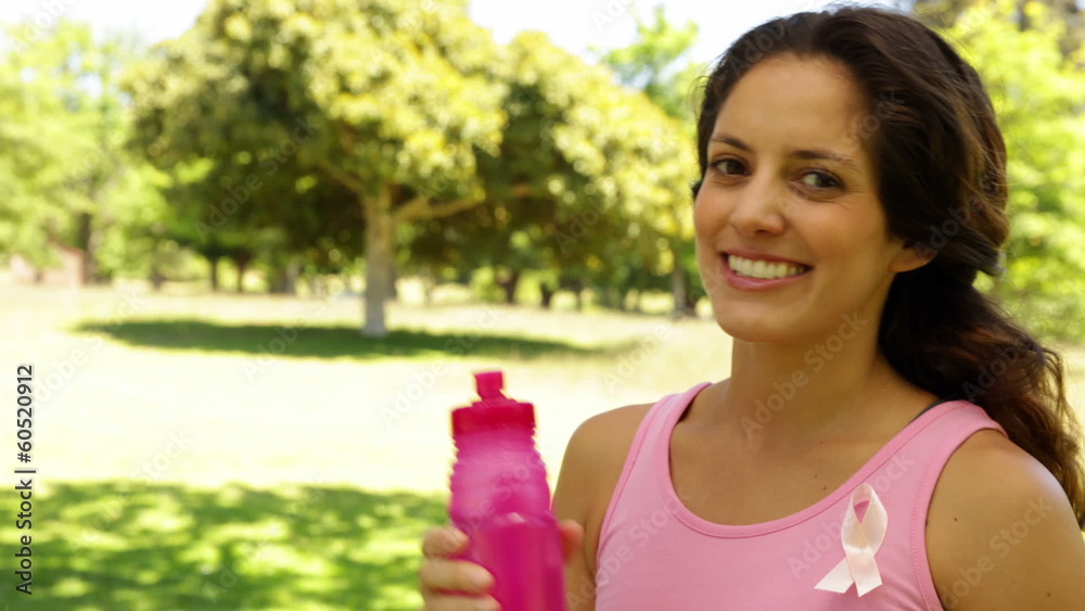 Happy woman wearing pink for breast cancer awareness Happy woman wearing pink for breast cancer awareness