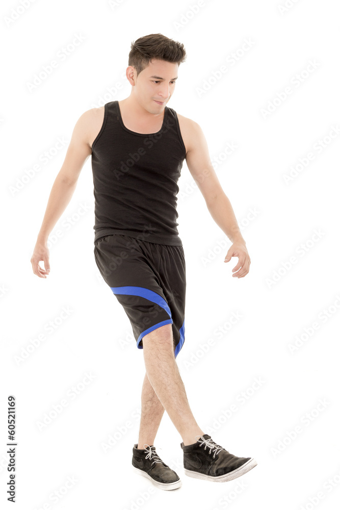 hispanic man in sporty outfit kicking