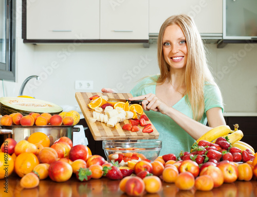 woman cutting fruits for sala