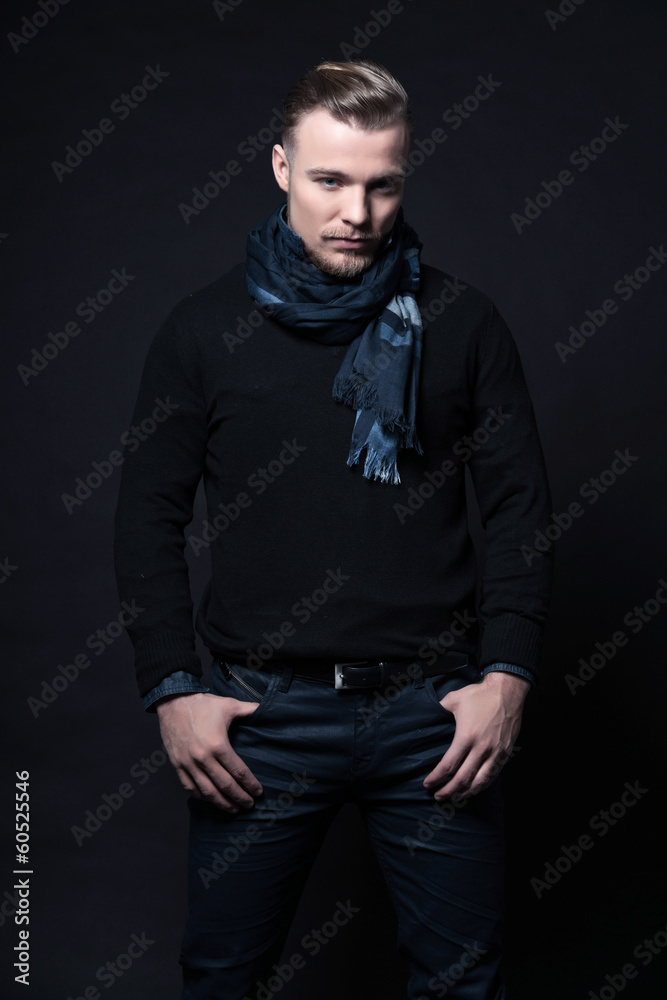 Man winter fashion. Wearing black sweater and scarf. Blonde hair Man winter fashion. Wearing black sweater and scarf. Blonde hair