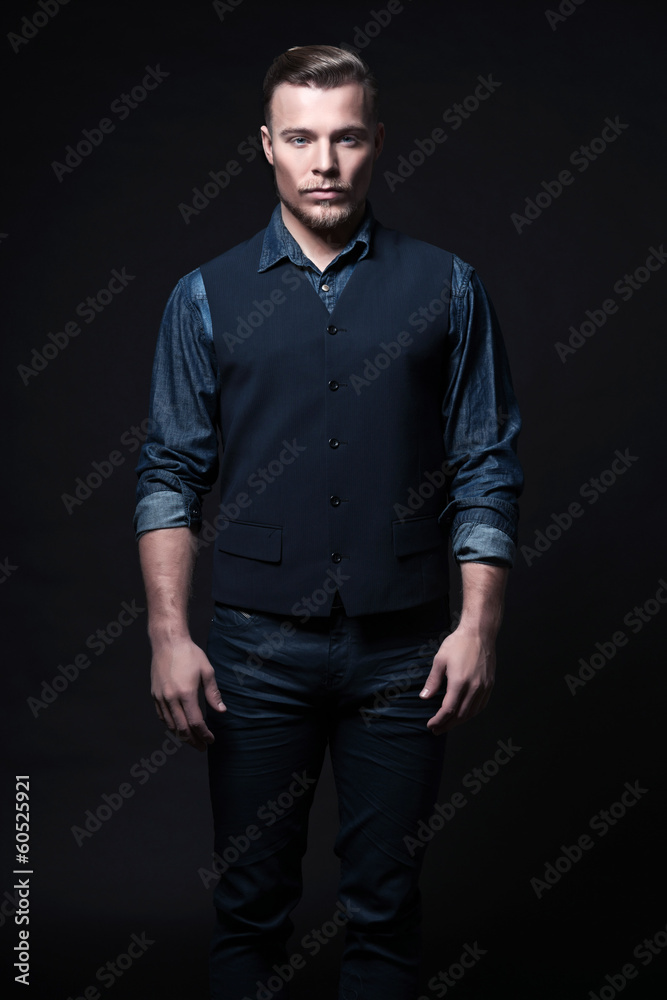 Retro winter fashion man. Wearing blue jeans shirt with gilet an Retro winter fashion man. Wearing blue jeans shirt with gilet an