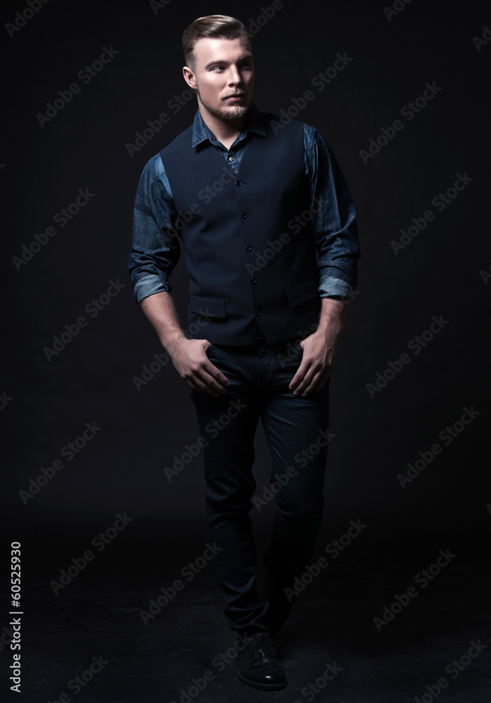 Retro winter fashion man. Wearing blue jeans shirt with gilet an Retro winter fashion man. Wearing blue jeans shirt with gilet an