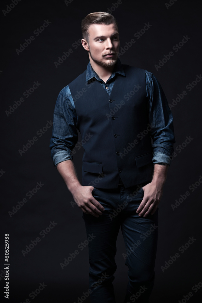 Retro winter fashion man. Wearing blue jeans shirt with gilet an Retro winter fashion man. Wearing blue jeans shirt with gilet an