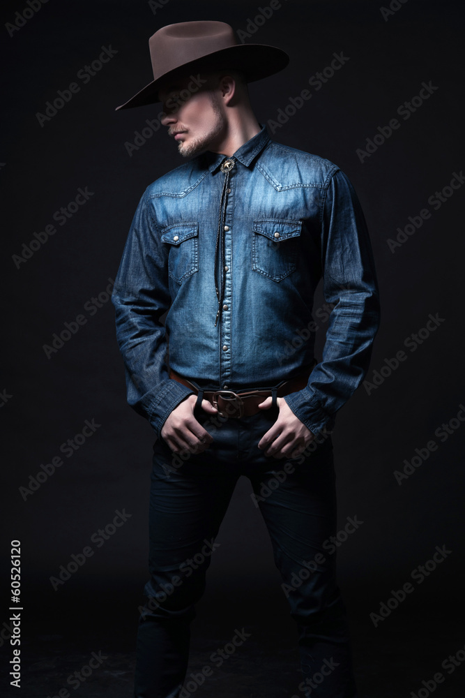 Modern fashion cowboy. Wearing brown hat and blue jeans shirt. B Stock  Photo | Adobe Stock