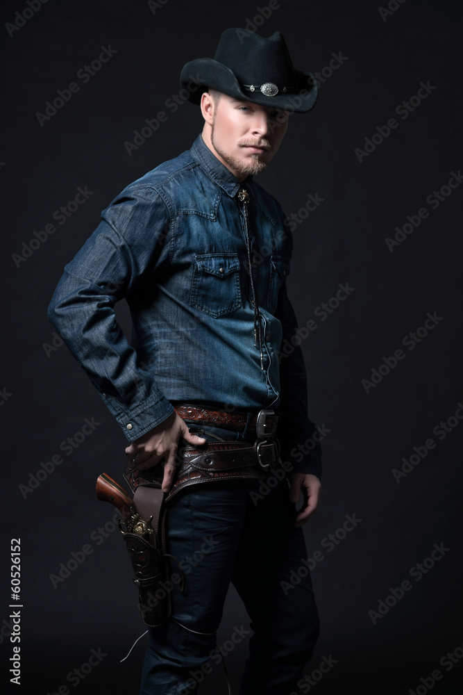Modern fashion cowboy. Wearing black hat and blue jeans shirt. P Modern fashion cowboy. Wearing black hat and blue jeans shirt. P