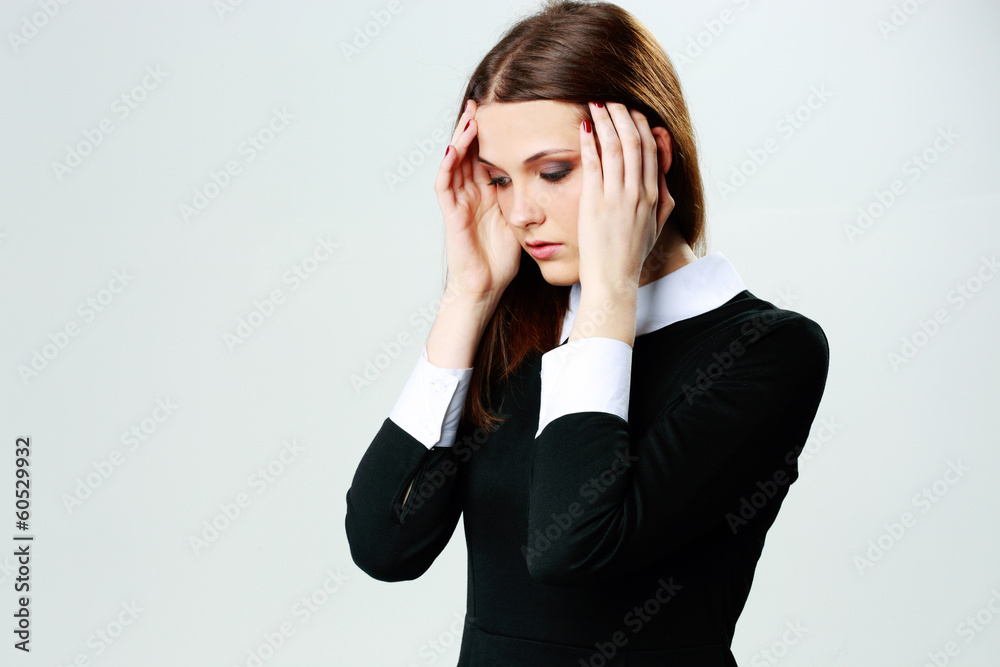 Portrait of a young woman touching her head with headache Portrait of a young woman touching her head with headache