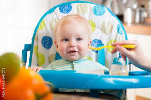 mom feeds funny baby with s...