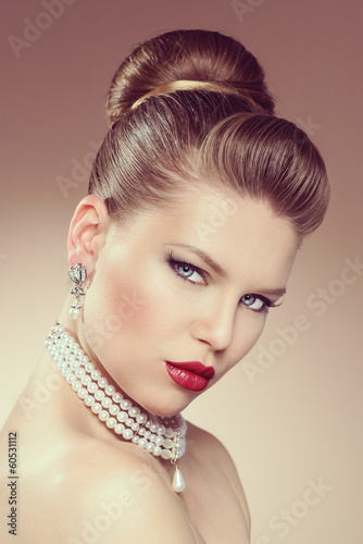 Vintage portrait of pretty woman in pearl necklace and earrings