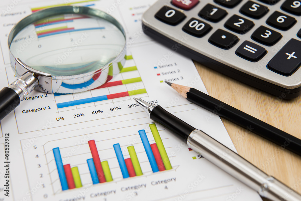 magnifying glass on business report magnifying glass on business report