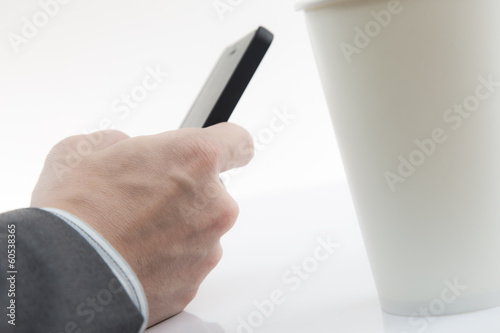 Businessman Using Cell Phone with coffee cup
