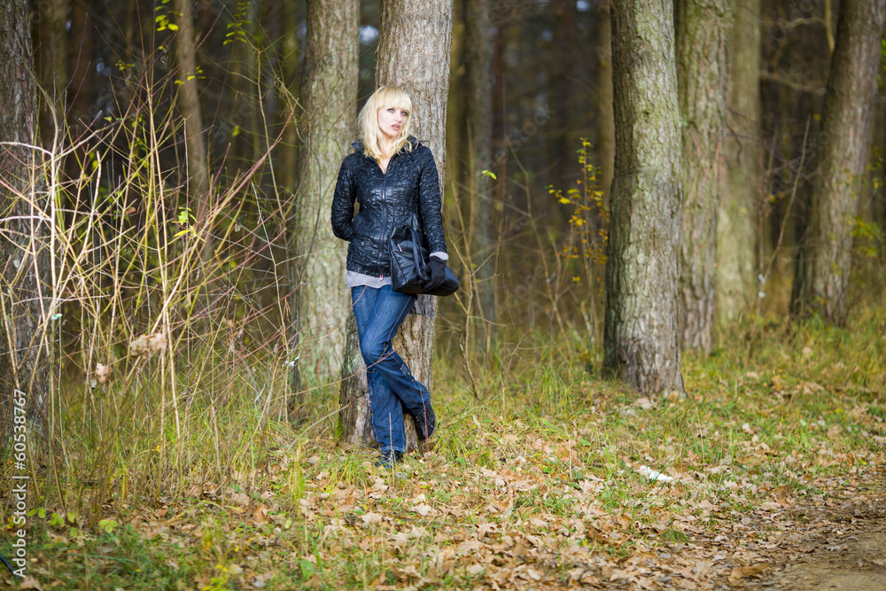 Beautiful young woman walks on autumn park Beautiful young woman walks on autumn park