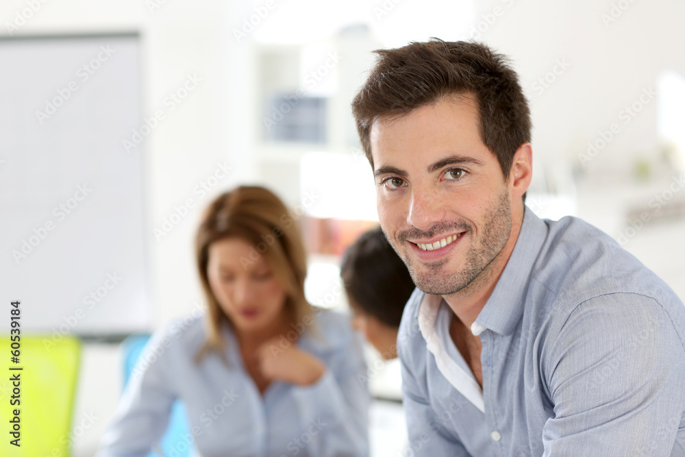 Smiling businessman attending work meeting Smiling businessman attending work meeting