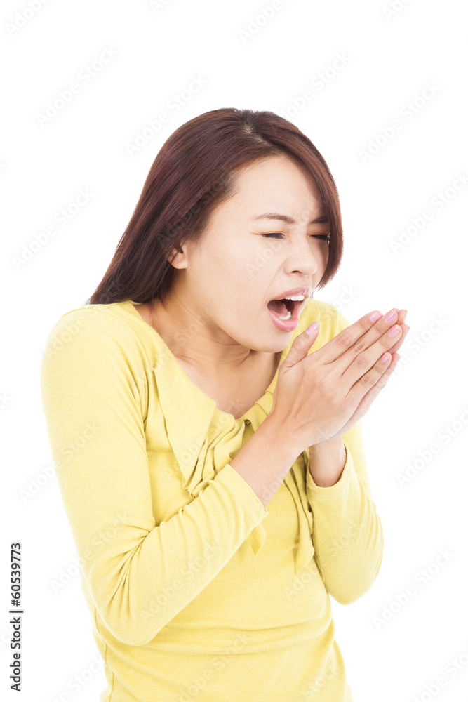 young woman blowing to warm hands in cold day young woman blowing to warm hands in cold day