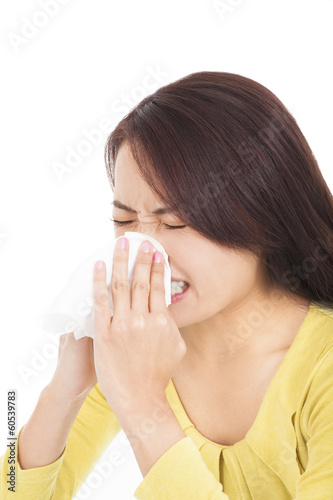 young woman is sneezing with painful face