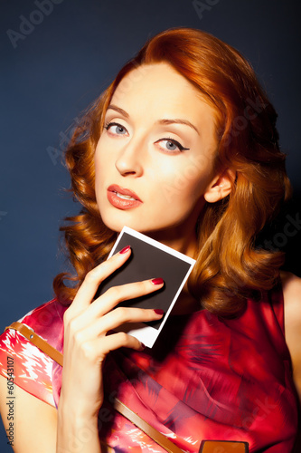 Girl with retro style polaroid camera. photo