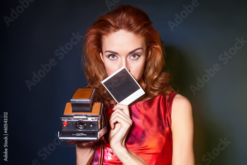 Girl with retro style polaroid camera. photo