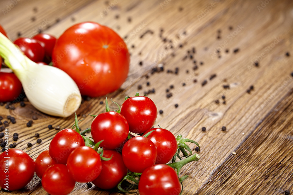 Red tomatoes with pepper and garlic on old wooden table Red tomatoes with pepper and garlic on old wooden table