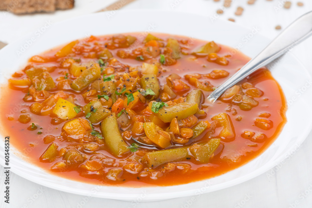 Spicy tomato soup with green lentils and vegetables, close-up Spicy tomato soup with green lentils and vegetables, close-up