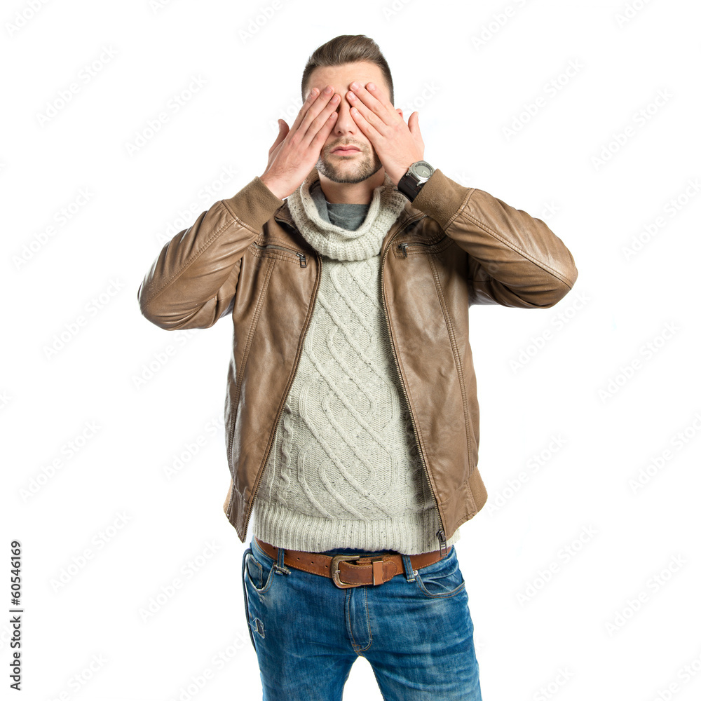 Men covering his eyes over white background