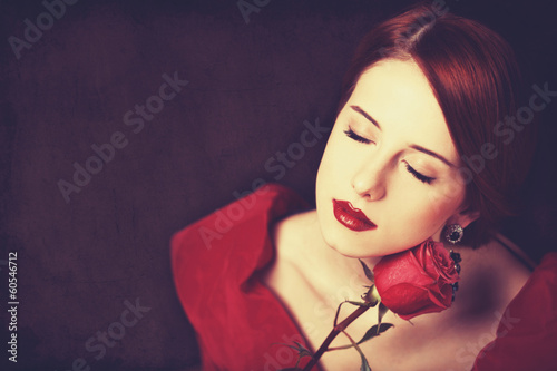 Canvas Print Beautiful redhead women with rose.