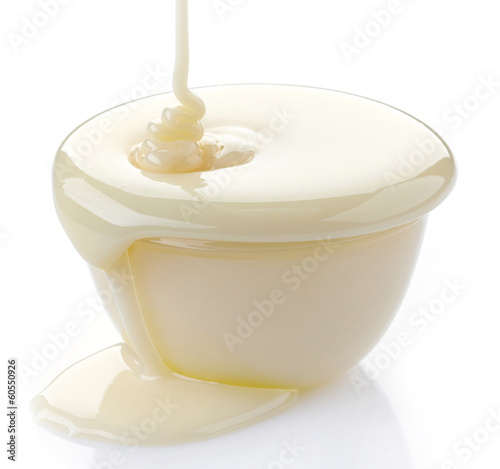 pouring condensed milk with sugar in a bowl photo