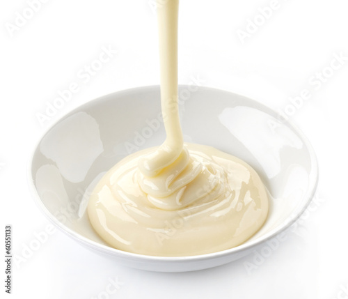 pouring condensed milk with sugar in a bowl